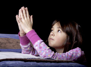 Girl praying. Copyrighted © image. Licensed.