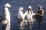 Tyree being baptized in the river.