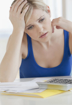 Woman working on finances. Copyrighted photograph. Licensed.
